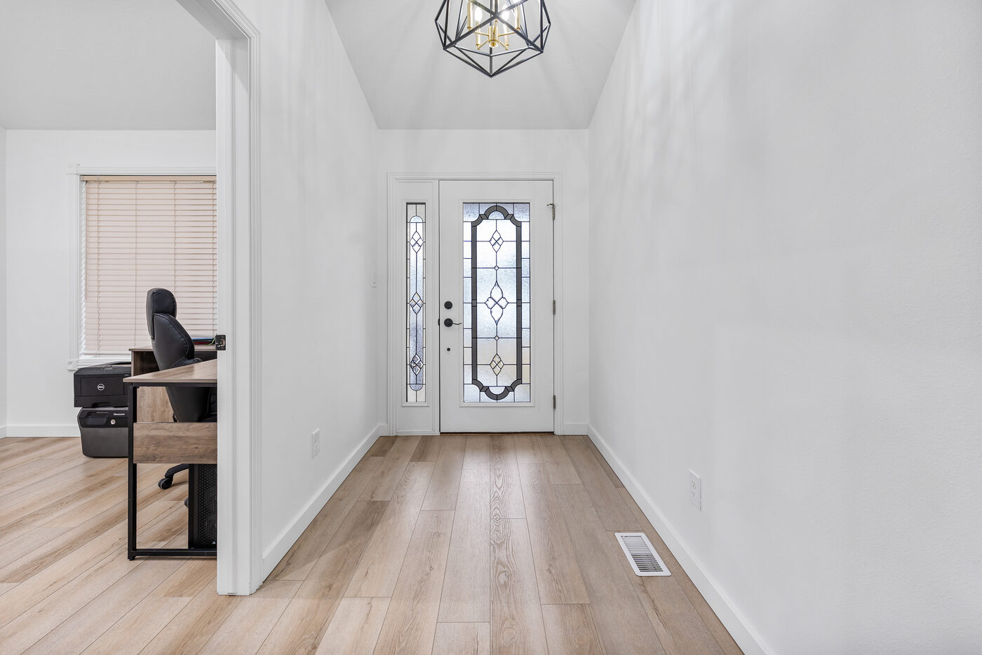 Entry foyer with stained glass door and geometric pendant light — 625 Vale Lane