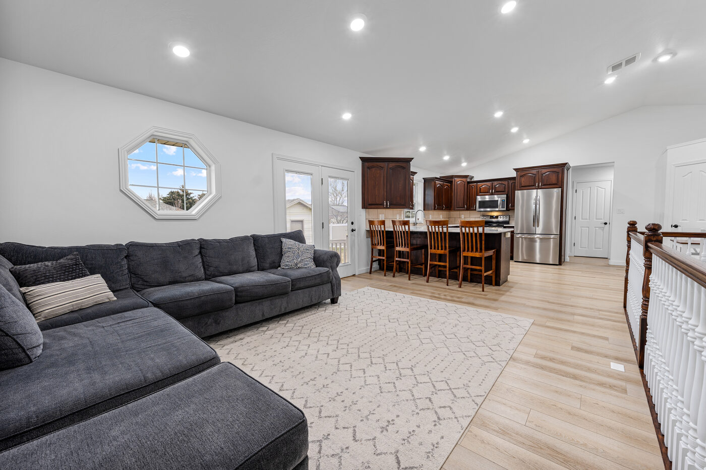 Open concept view from living room to kitchen with vaulted ceilings