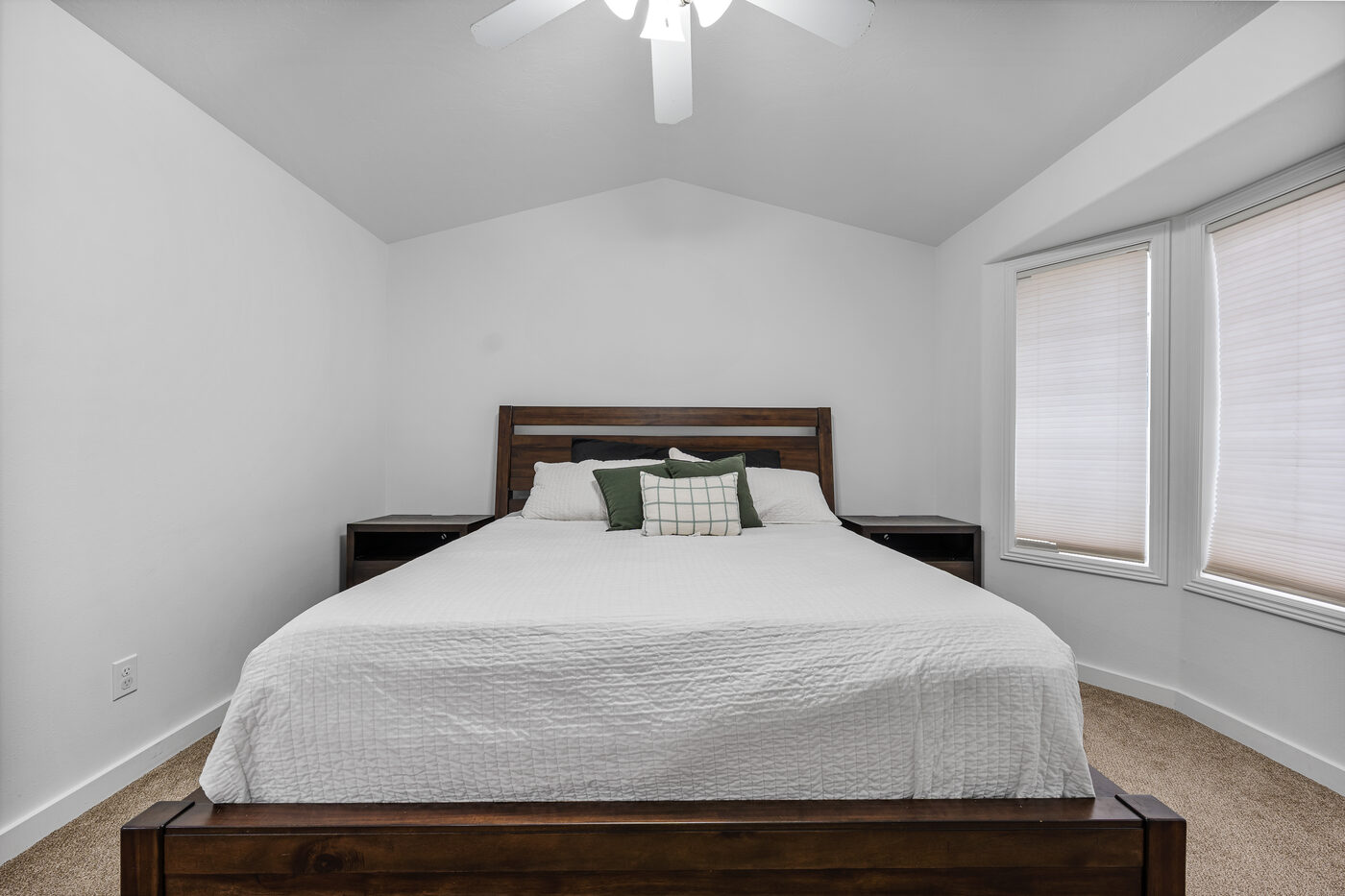 Master bedroom wider angle showing vaulted ceiling and natural light